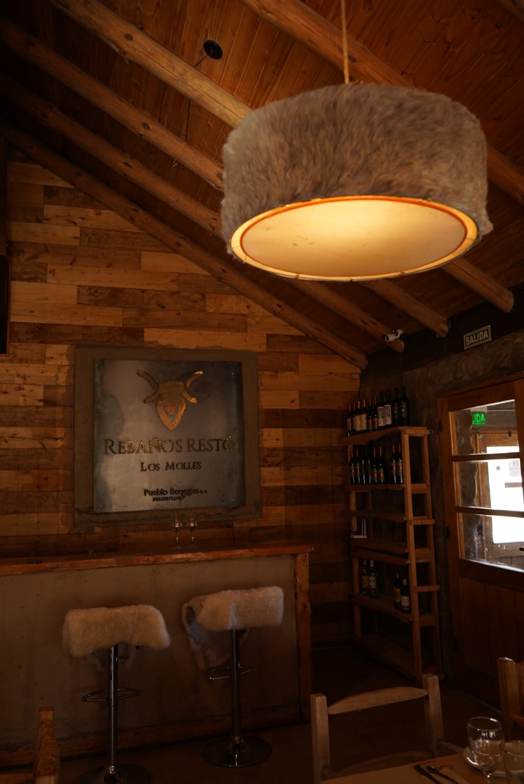 Bodega del restaurant con la carta de vinos y la barra del salón.
